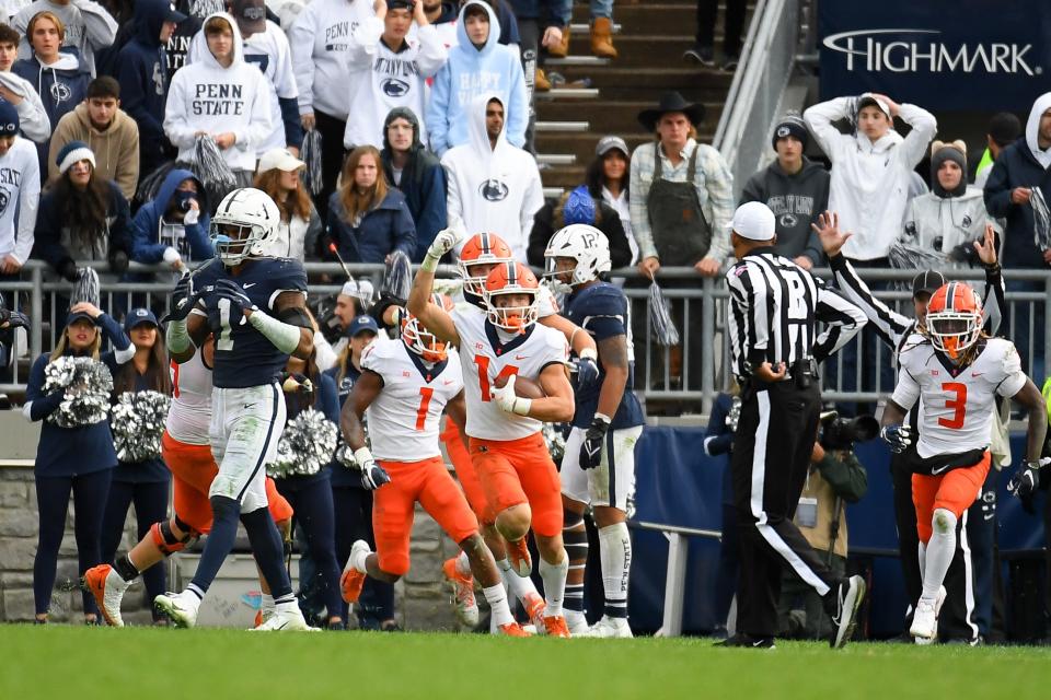 Illinois wide receiver Casey Washington (14) celebrates his game winning catch in the ninth overtime against Penn State.