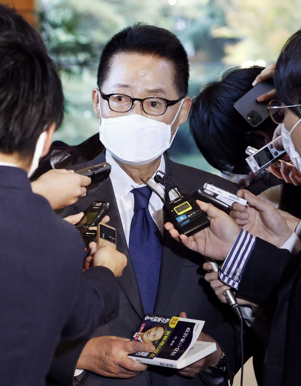 South Korea's National Intelligence Service Director Park Jie-won is surrounded by journalists after meeting with Japanese Prime Minister Yoshihide Suga at the prime minister's office in Tokyo Tuesday, Nov. 10, 2020. Suga, in a sign of thaw of his country's troubled relations with Seoul, met with the South Korean top intelligence official Tuesday and stressed the importance of their bilateral relationship as well as a three-way cooperation with the United States in tackling North Korea and other regional concerns. (Jun Hirata/Kyodo News via AP)