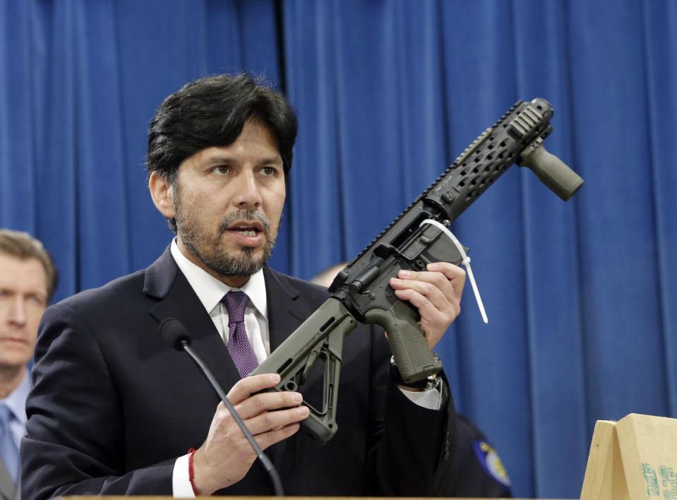 FILE - In this Jan. 13, 2014 file photo, former California State Sen. Kevin de Leon, D-Los Angeles, displays a homemade fully automatic rifle, confiscated by the Department of Justice, at the Capitol in Sacramento, Calif. California is among a handful of states taking tough actions to limit the availability of guns including military-style assault weapons, restrict the capacity of ammunition magazines and require background checks for purchasing bullets. But those steps and future gun control laws passed by Democratic-leaning states could face an uphill battle as the federal court system becomes increasingly dominated by conservative Republican appointees.(AP Photo/Rich Pedroncelli, File)