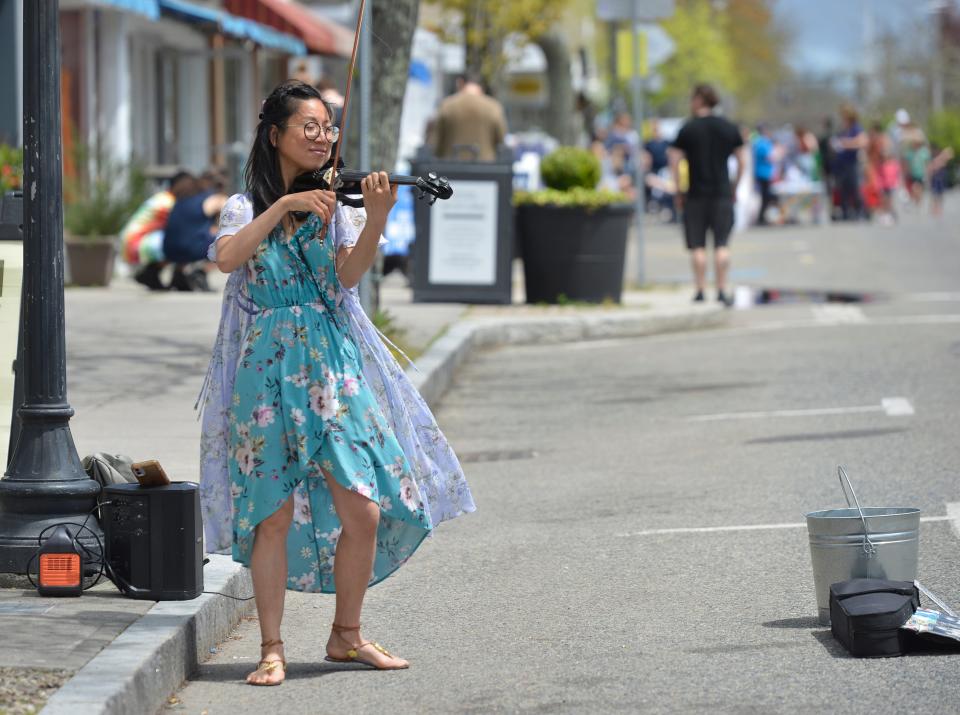 Vivian Luo, who is known as violinviiv, plays her violin during Hyannis Open Streets. Luo was one of several musicians and bands to perform Sunday during the event. Hyannis Open Streets was held along Main Street Sunday afternoon. Main Street was closed between Barnstable and Sea Streets for family friendly activities. To see more photos, go to www.capecodtimes.com/news/photo-galleries. Merrily Cassidy/Cape Cod Times