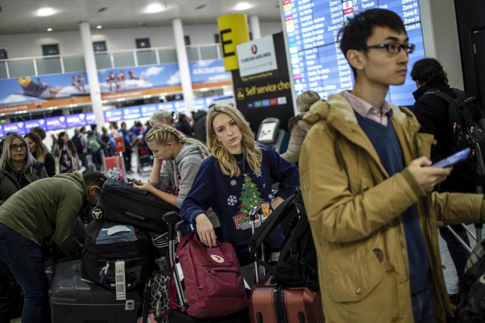 Passengers queue while waiting for announcements at Gatwick South Terminal (Getty Images)