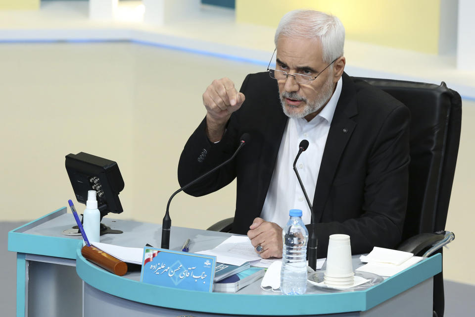 In this photo made available by the government-affiliated Young Journalists Club, presidential candidate Mohsen Mehralizadeh speaks in a televised debate in a state-run television studio, in Tehran, Iran, on Saturday, June 5, 2021. Elections are scheduled for June 18. (Morteza Fakhri Nezhad/YJC via AP)