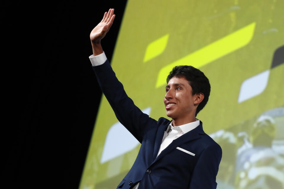 Colombia's Egan Bernal waves to the public during the presentation of the Tour de France 2020 cycling race, in Paris, Tuesday Oct. 15, 2019. The 107th edition of the race starts on June 27 2019 to end on the Champs-Elysees avenue on July 19. (AP Photo/Thibault Camus)