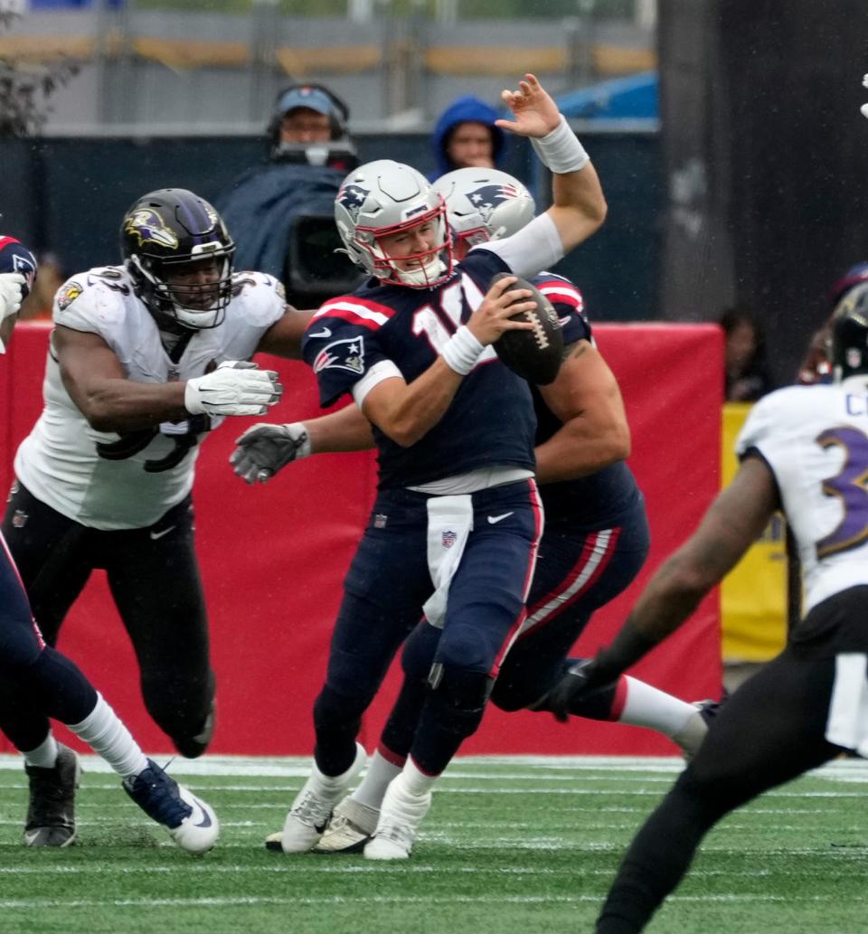 Patriots QB Mac Jones twist to get away from Raven defender Odafe Oweh in the fourth quarter.  This was not the play Jones injured his ankle.   [The Providence Journal / Kris Craig]