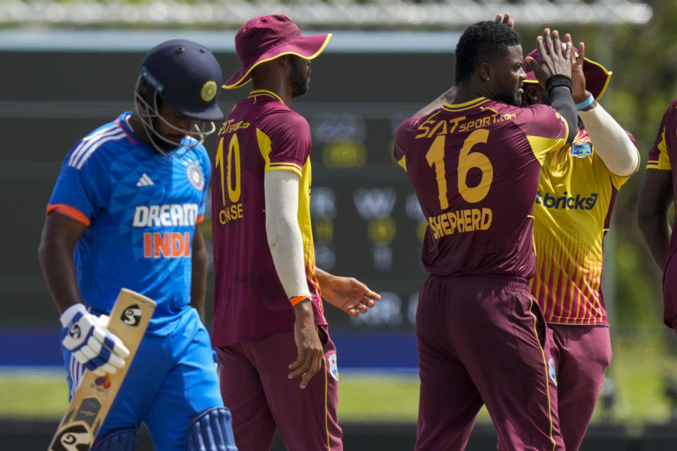 West Indies' Romario Shepherd celebrates the dismissal of India's Sanju Samson, left, during the fifth T20 cricket match at Central Broward Regional Park in Lauderhill, Fla, Sunday, Aug. 13, 2023. (AP Photo/Ramon Espinosa)