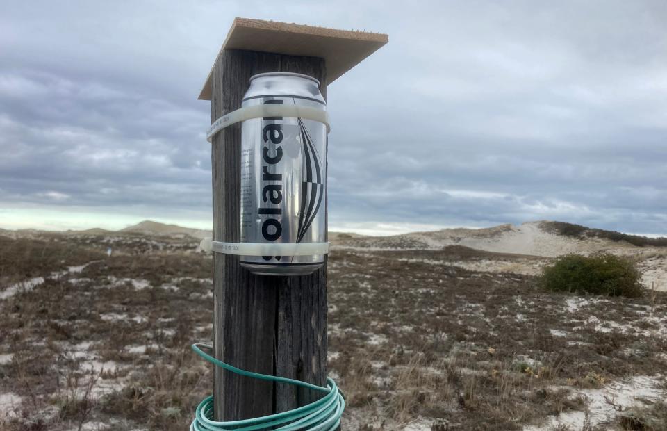 A Solar Can pinhole camera mounted on a clothesline pole at Sandy Neck where it recorded 113 days of the sun's path, rising ever higher each day of the winter months.