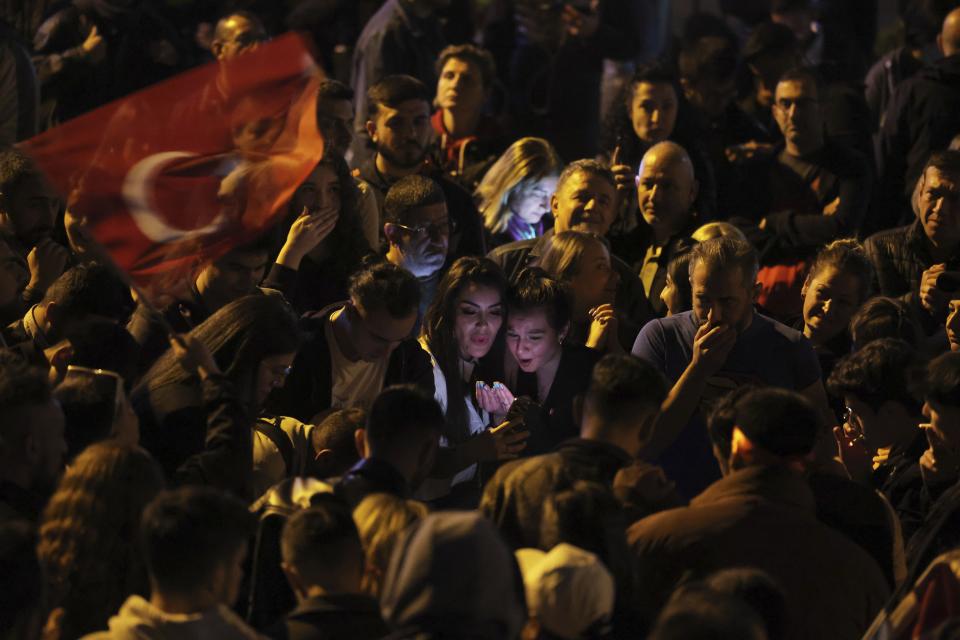 Supporters of Republican People's Party use their cellphones to watch the election results outside the headquarters of CHP, in Ankara, Turkey, Sunday, May 14, 2023. More than 64 million people, including 3.4 million overseas voters, were eligible to vote. (AP Photo)