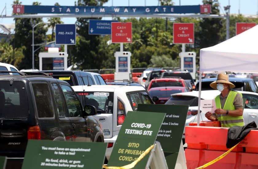 LOS ANGELES, CA - JUNE 09, 2020 - - Traffic flows once again into the Dodgers Stadium parking lot for a free drive-up test for COVID-19 in Los Angeles on June 9, 2020. The testing site was closed for a few days during protests over the death of George Floyd. (Genaro Molina / Los Angeles Times)