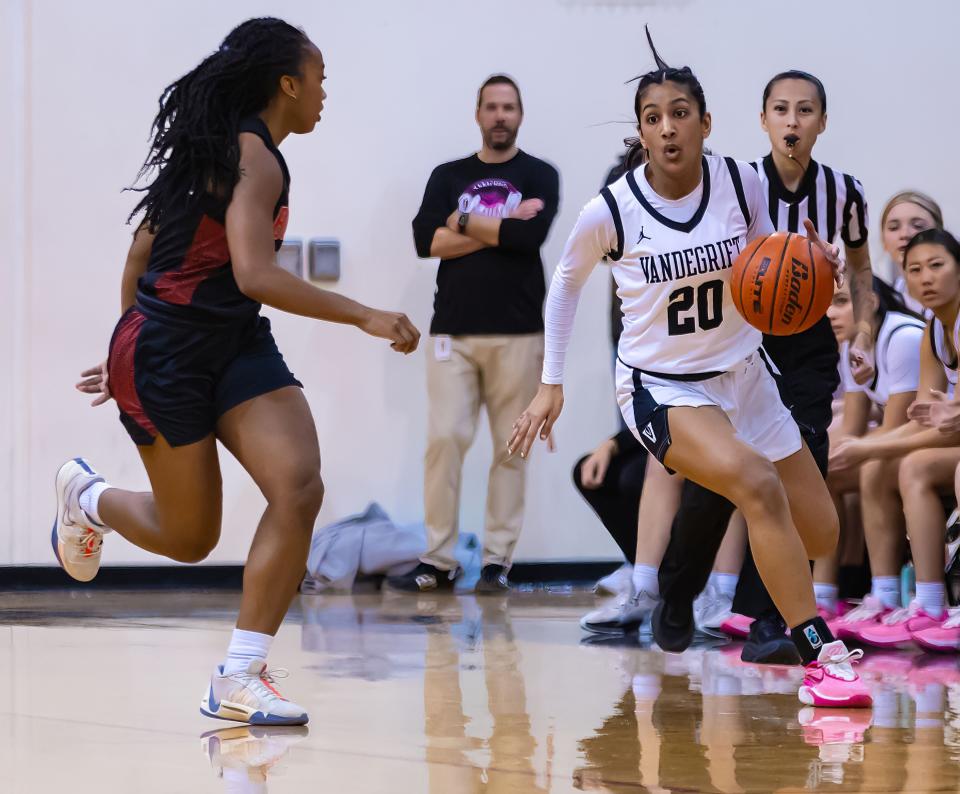 Vandegrift Vipers guard Saania Khawaja (20) brings the ball to home court as \bb10 defends during the first period at the Bi-District Class 6A-IV girls basketball playoff round on Tuesday, Feb 13, 2024, at Vandegrift High School in Austin, TX.