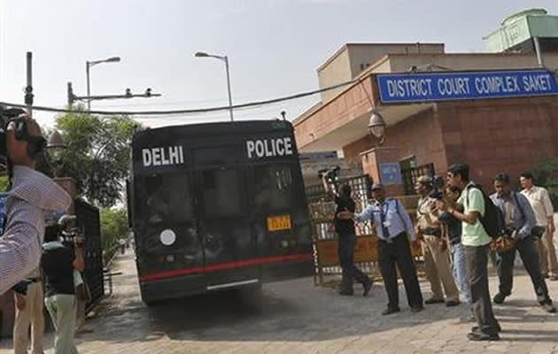 A police vehicle carrying four men accused of the gang rape of a 23-year-old woman on a bus on December 16, enters a court in New Delhi September 10, 2013. REUTERS/Adnan Abidi