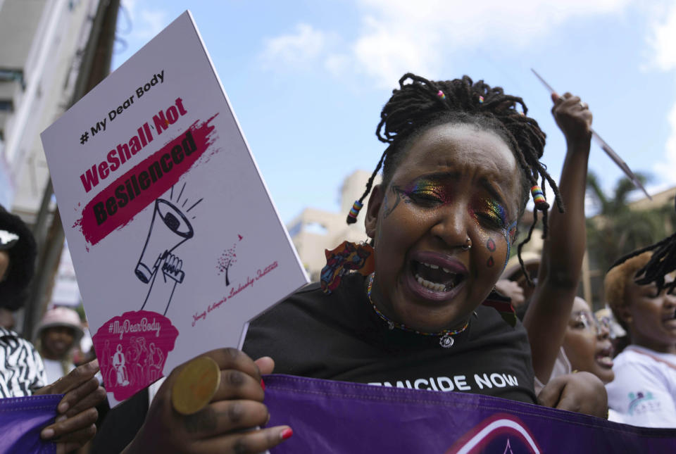 A woman holds a placard during a procession to protest against the rising cases of femicide, in downtown Nairobi, Kenya, Saturday, Jan. 27, 2024. Thousands of people marched in cities and towns in Kenya during protests Saturday over the recent slayings of more than a dozen women. The anti-femicide demonstration was the largest event ever held in the country against sexual and gender-based violence. (AP Photo/Brian Inganga)