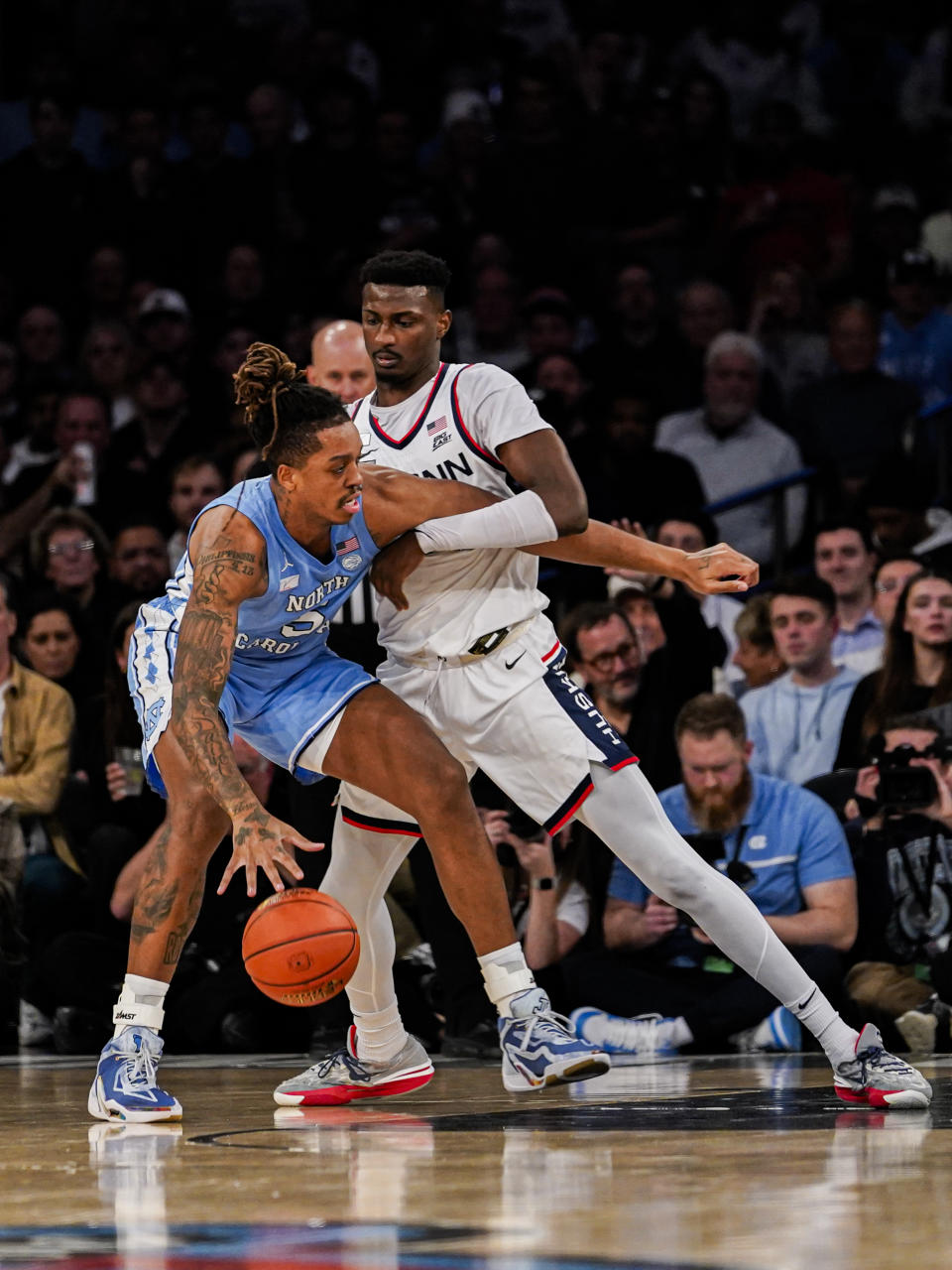 UConn forward Samson Johnson defends North Carolina forward Armando Bacot during the first half of an NCAA college basketball game in New York, Tuesday, Dec. 5, 2023. (AP Photo/Peter K. Afriyie)