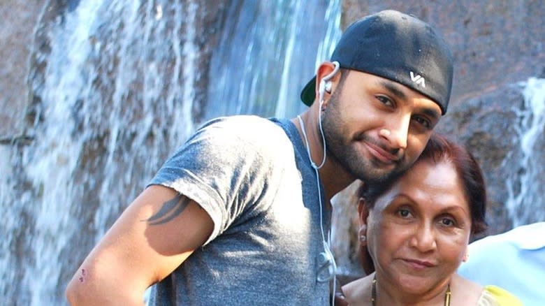 Ashish Alfred and mother pose near waterfall