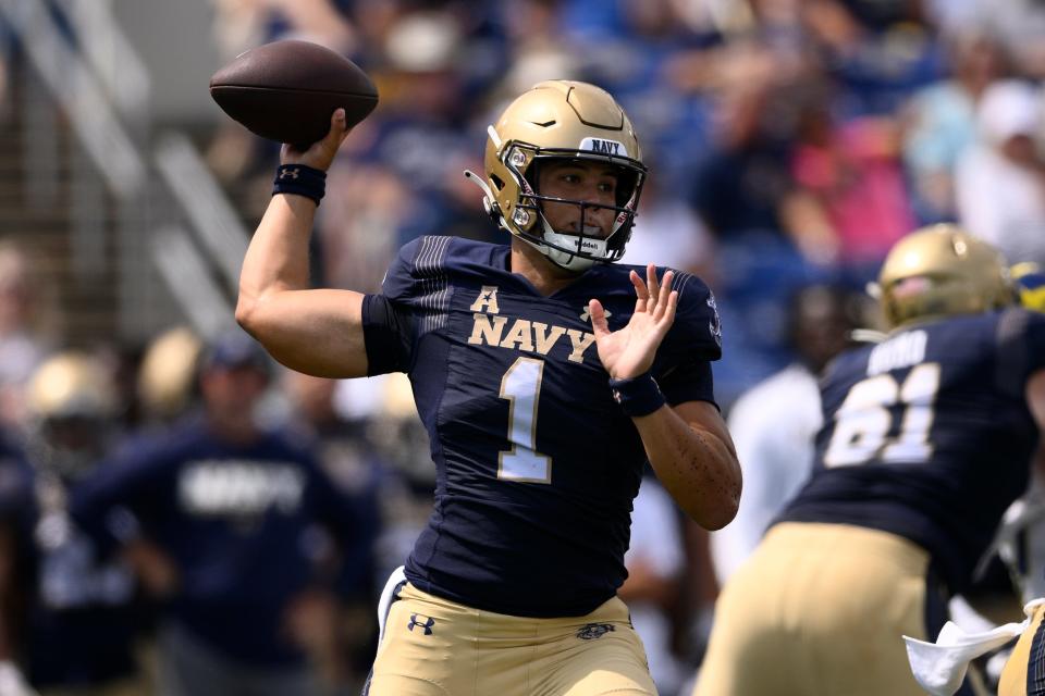 Navy quarterback Tai Lavatai passes during the first half of an NCAA college football game against Delaware.