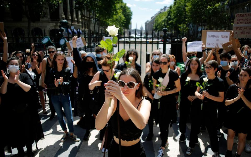 Feminist activists protest against French President Emmanuel Macron's appointment of an interior minister who has been accused of rape - AP Photo/Thibault Camus