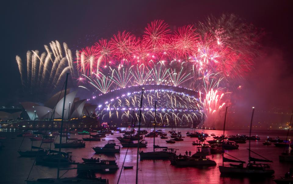 <p>Fireworks explode over the Sydney Opera House and Harbour Bridge as New Year celebrations begin in Sydney.  (AP Photo/Mark Baker)</p>AP