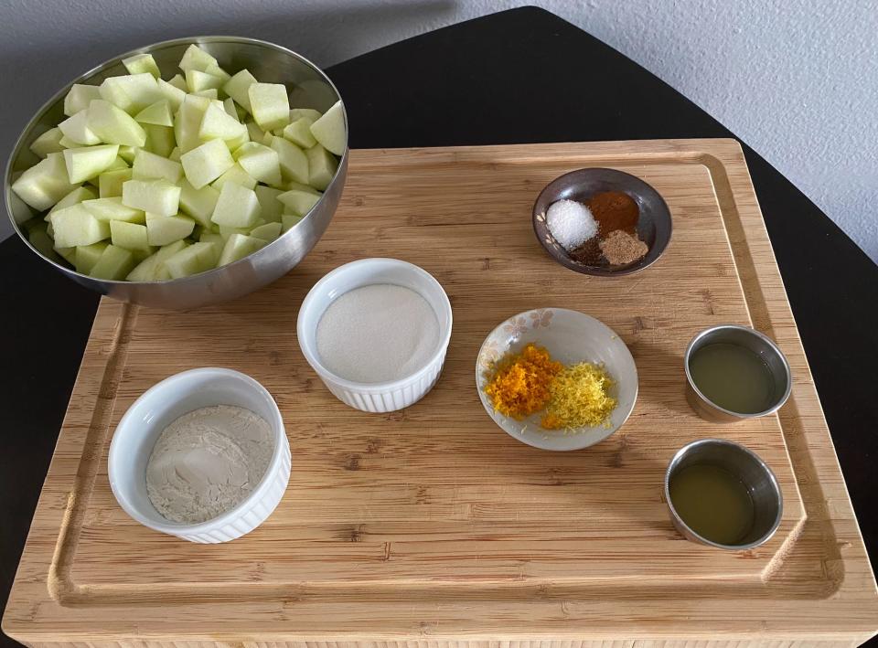 ingredients for ina garten's apple pie on a kitchen cutting board