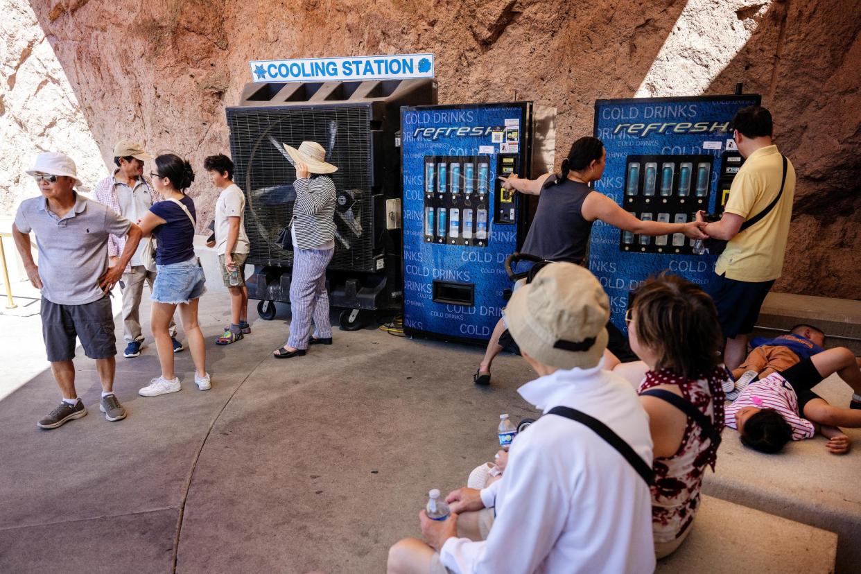 <span>Tourists find shade from the sun at a cooling station at the Hoover Dam in Boulder City, Nevada, during a heat wave on 8 June 2024.</span><span>Photograph: Jim Watson/AFP/Getty Images</span>