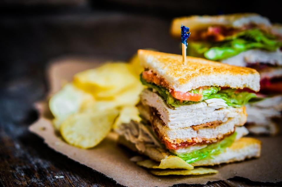 <span class="caption">The club sandwich: A perfect blend of elegance and blandness.</span> <span class="attribution"><a class="link " href="https://www.shutterstock.com/image-photo/club-sandwich-on-rustic-wooden-background-188159096" rel="nofollow noopener" target="_blank" data-ylk="slk:Alena Haurylik;elm:context_link;itc:0;sec:content-canvas">Alena Haurylik</a></span>