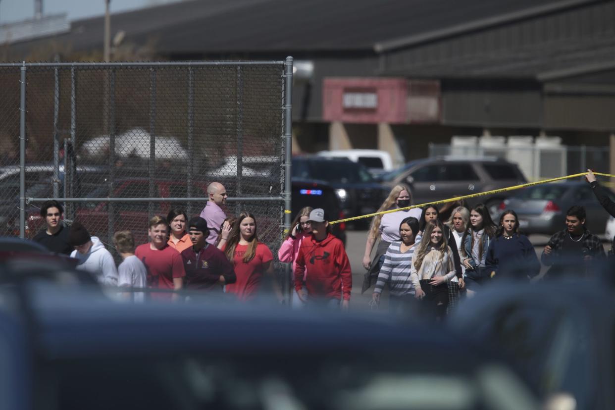 Students walk past police tape after a school shooting at Rigby Middle School in Rigby, Idaho on Thursday, May 6. 