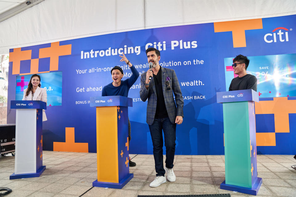 From left, Cheryl Wee, Benjamin Kheng and Xiao Ming participate in a wealth literacy quiz hosted by Rishi Budhrani (with mic).