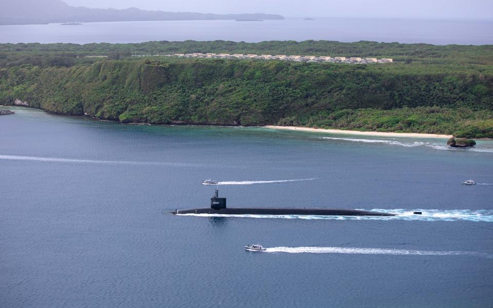 The Ohio-class ballistic-missile submarine USS Maine (SSBN 741) arrives at Naval Base Guam for a logistics stop on April 18.