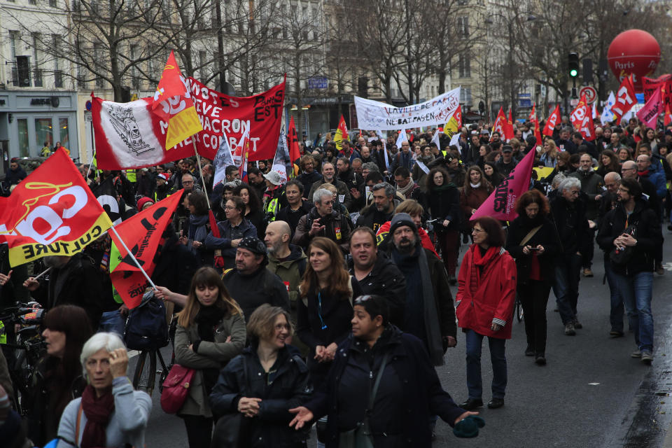 Protesters march during a demonstration Thursday, Dec. 19, 2019 in Paris. Traffic improved slightly on French trains Thursday as nationwide strikes over the government's retirement reform entered a 15th day and small signs of progress emerged in negotiations with unions. (AP Photo/Michel Euler)