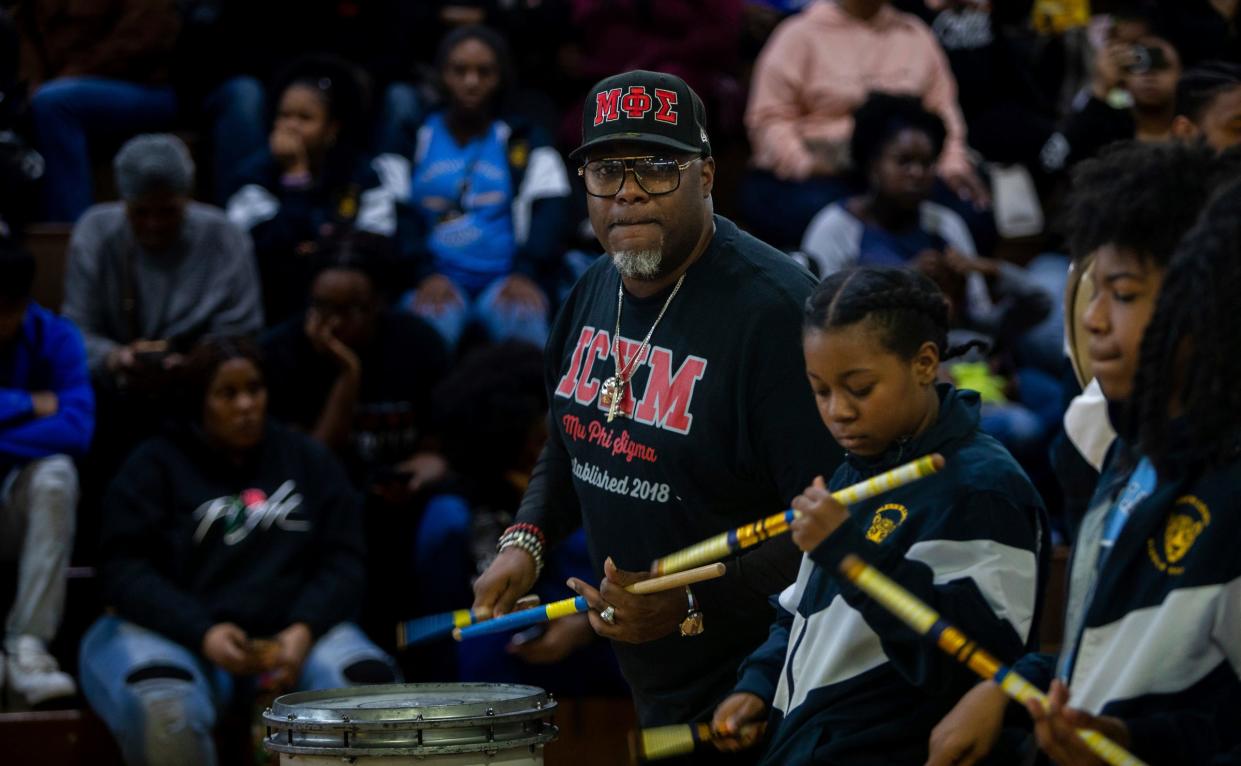 Joey Donaldson, founder of Forever Illustrating Real Entertainment (FIRE), performs in front of a large crowd alongside other students during the 8th annual Harvest Festival inside the University High School Academy's gymnasium in Detroit on Wednesday, Nov. 22, 2023.