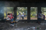 People celebrate South Africa's Heritage Day by cooking a barbecue at Zoo Lake park in Johannesburg Thursday Sept. 24, 2020. As the number of worldwide Covid-19 death is nearing the million mark, coronavirus related case numbers and deaths in South Africa hit the lowest in months. (AP Photo/Jerome Delay)