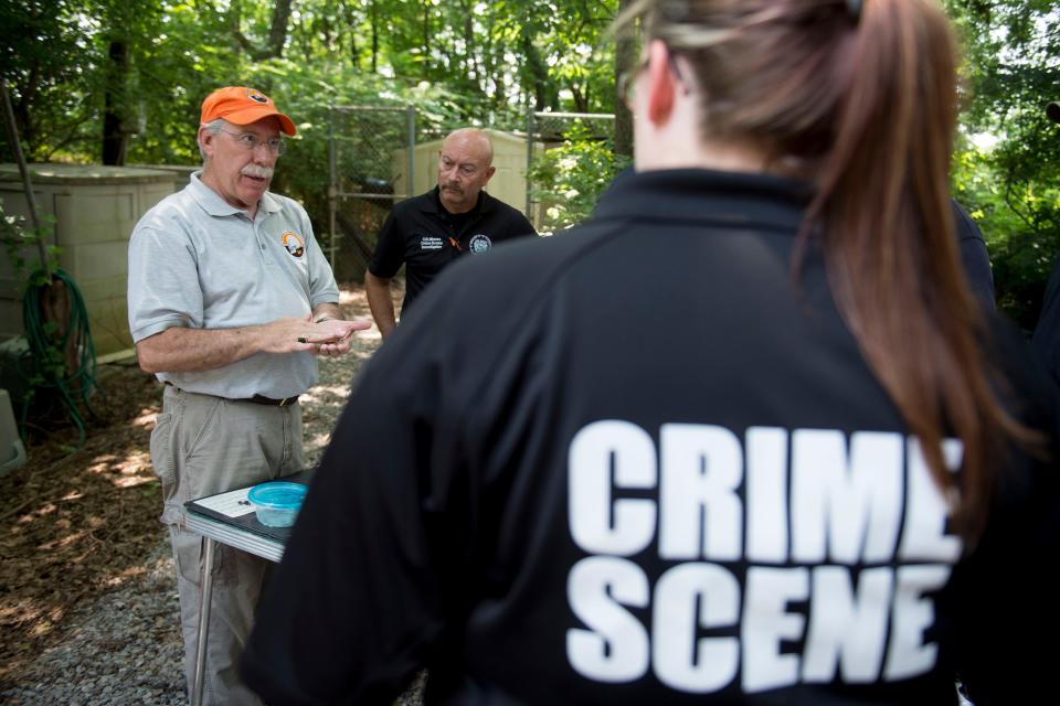 Dr. Randy Parce, a forensic odontologist, teaches a group of law enforcement professionals about using dental information for police investigations at the University of Tennessee's Forensic Anthropology Center.