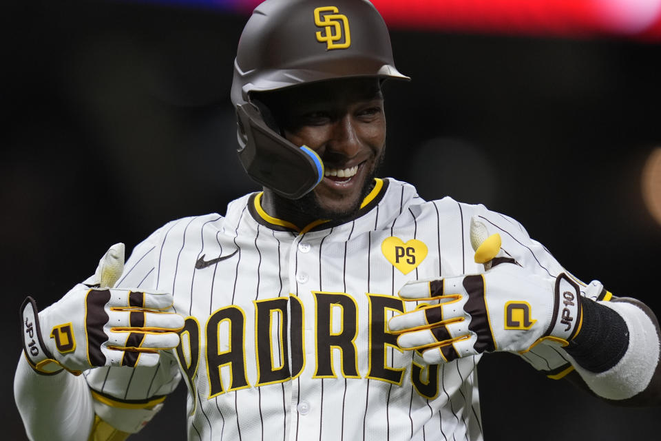 San Diego Padres' Jurickson Profar celebrates after hitting a grand slam during the sixth inning of a baseball game against the Washington Nationals, Tuesday, June 25, 2024, in San Diego. (AP Photo/Gregory Bull)