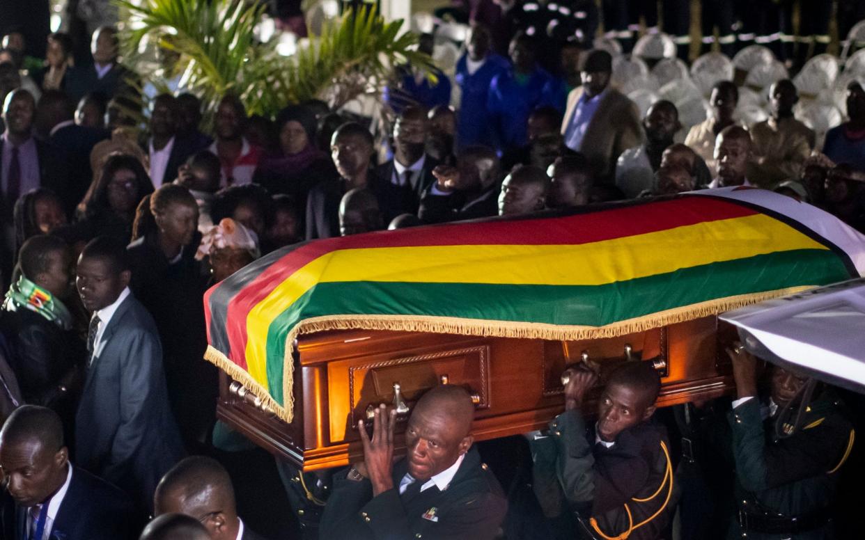 The body of former president Robert Mugabe arrives to lie in state inside his official residence in the capital Harare, Zimbabwe Wednesday, Sept. 11, 2019.  - AP