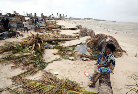 Children sit amongst storm debris left in the aftermath of Cyclone Idai, in Beira, Mozambique March 23, 2019. REUTERS/Siphiwe Sibeko