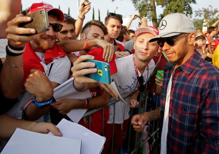 Italian Grand Prix 2016 - Monza, Italy - 02/9/16 - Mercedes' Lewis Hamilton of Britain poses with fans as he arrives for the first free practice. REUTERS/Max Rossi