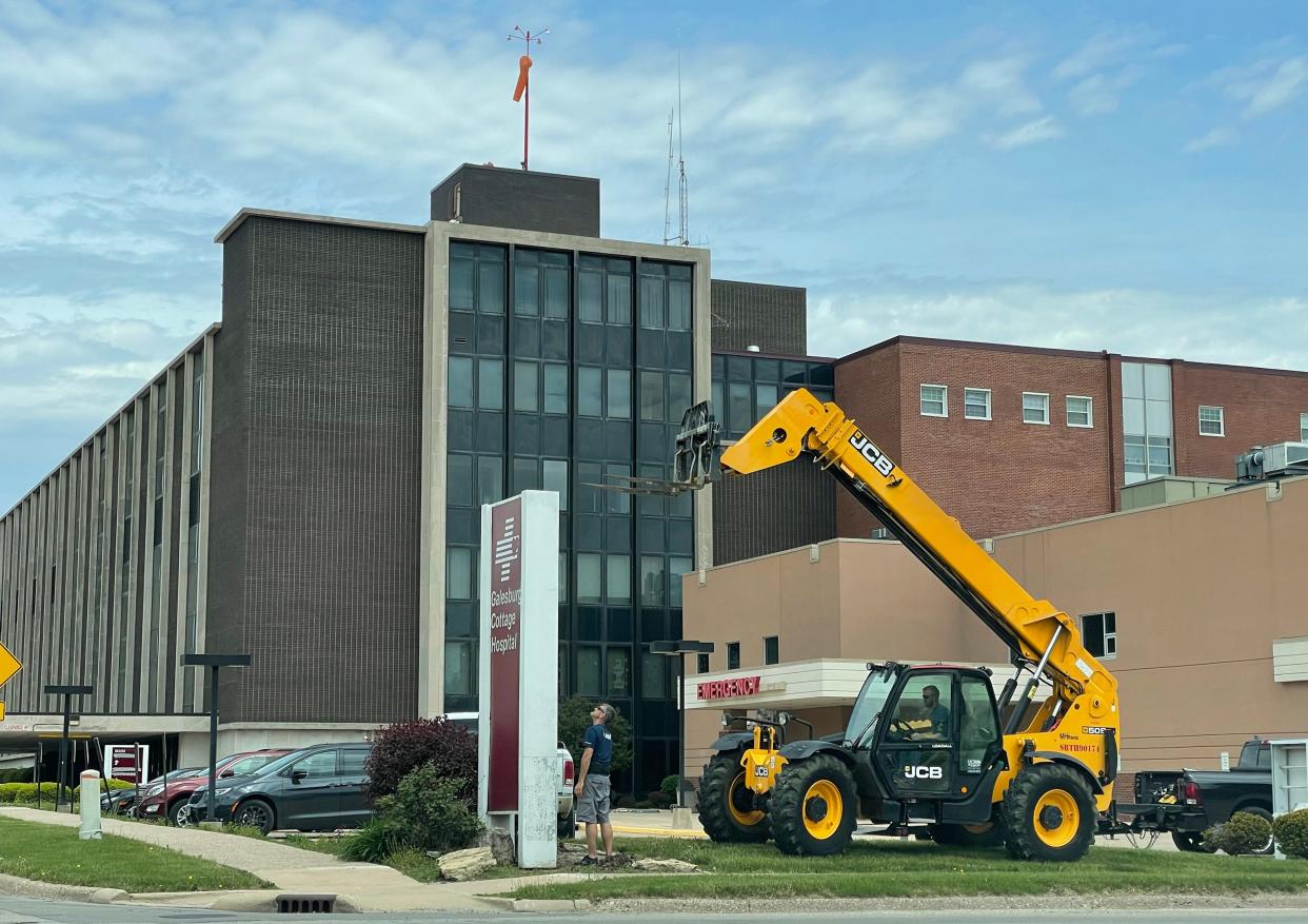 Workers remove Cottage Hospital signage from the southwest portion of the property near the emergency room on Tuesday, May 17, 2022.