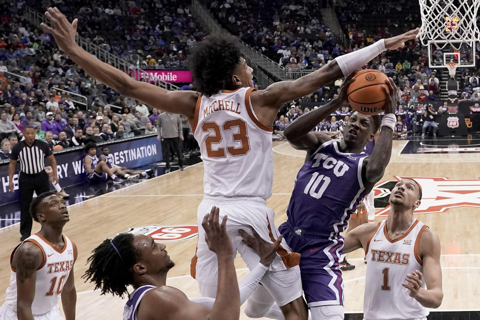 TCU guard Damion Baugh (10) shoots under pressure from Texas forward Dillon Mitchell (23) during the second half of an NCAA college basketball game in the semifinal round of the Big 12 Conference tournament Friday, March 10, 2023, in Kansas City, Mo. (AP Photo/Charlie Riedel)