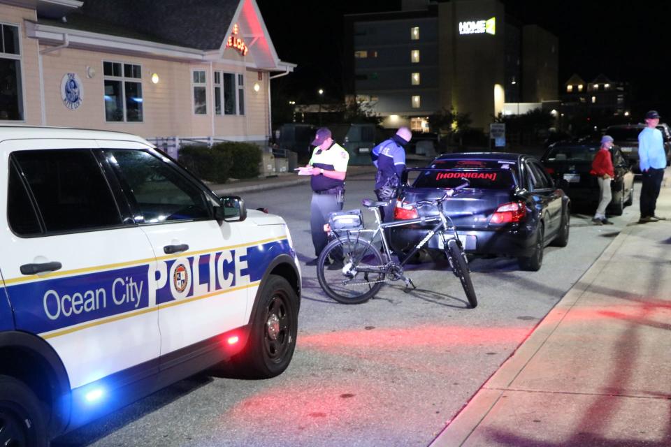 Ocean City, Md., police officers pull over a vehicle at an intersection on Sept. 25, 2020, during a pop-up car rally known as H2Oi. The event attracts thousands of car enthusiasts to Ocean City at the end of each September.