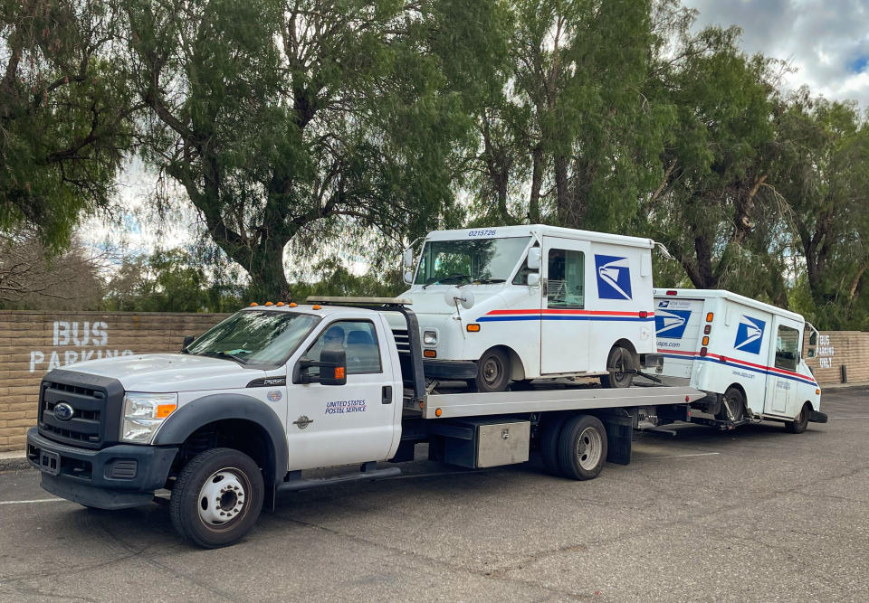 SOLVANG, CA - FEBRUARY 15: United States Postal Service tow truck prepares to haul away two broken down delivery vehicles on February 15, 2022, in Solvang, California. Because of its close proximity to Southern California and Los Angeles population centers, Santa Barbara County's Wine Country has become a popular weekend getaway destination for millions of tourists. (Photo by George Rose/Getty Images)