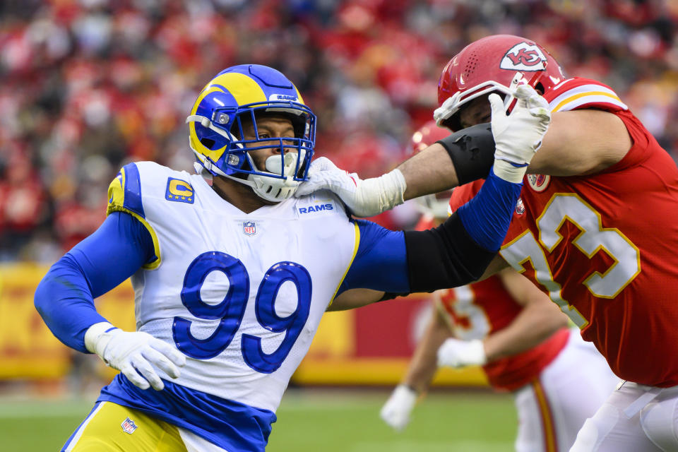 FILE - Los Angeles Rams defensive tackle Aaron Donald (99) battles Kansas City Chiefs guard Nick Allegretti (73) during the first half of an NFL football game, Sunday, Nov. 27, 2022 in Kansas City, Mo. Donald is on a short list for best defensive players ever but slipped a little on this list after an injury-shortened 2022 season. (AP Photo/Reed Hoffmann, File)