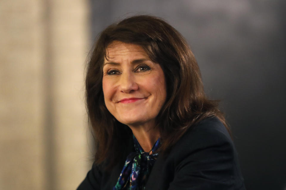 In this Monday, March 9, 2020, photo, Marie Newman smiles as she campaigns in the Archer Heights neighborhood of Chicago. Newman almost unseated Illinois Republican Rep. Dan Lipinski a staunch abortion opponent and one of the most conservative Democrats in Congress, in 2018, and is trying again in the March 17 primary. (AP Photo/Charles Rex Arbogast)