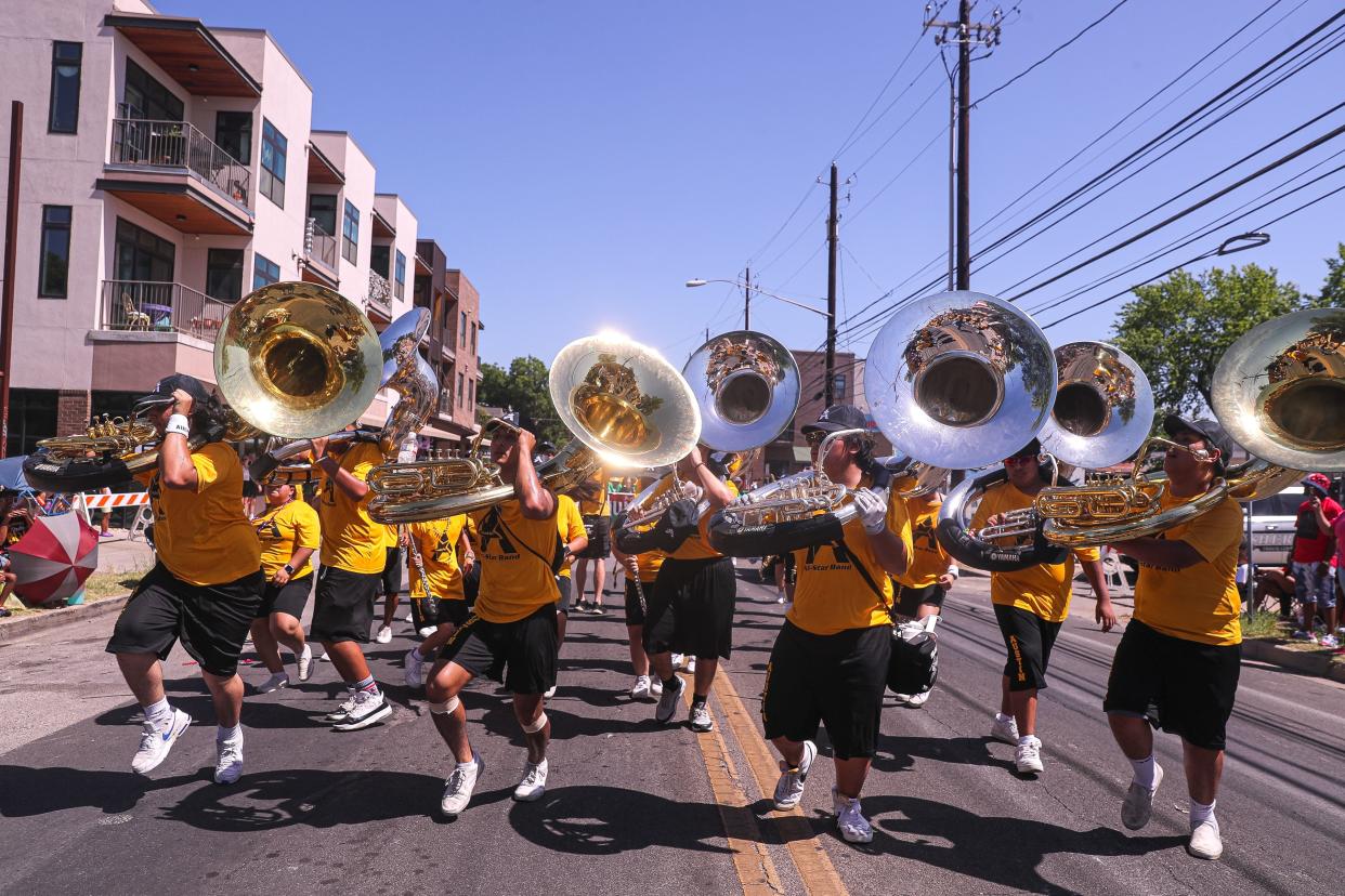 Tuba players from the Austin All-Star Band dance in the street during the annual Juneteenth parade in East Austin in 2022. This year's parade will be on Saturday and will be followed by a daylong festival in Rosewood Park.