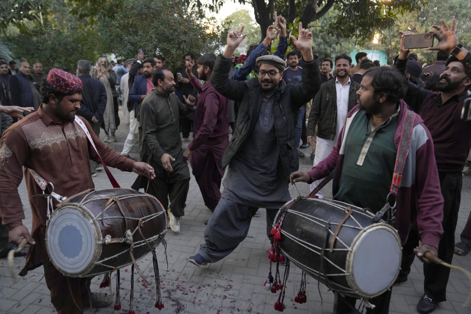 Supporters of Former Prime Minister Nawaz Sharif' party 'Pakistan Muslim League-N' dance to celebrate their party victory in the initial results of the country's parliamentary election, in Lahore, Pakistan, Friday, Feb. 9, 2024. (AP Photo/K.M. Chaudary)