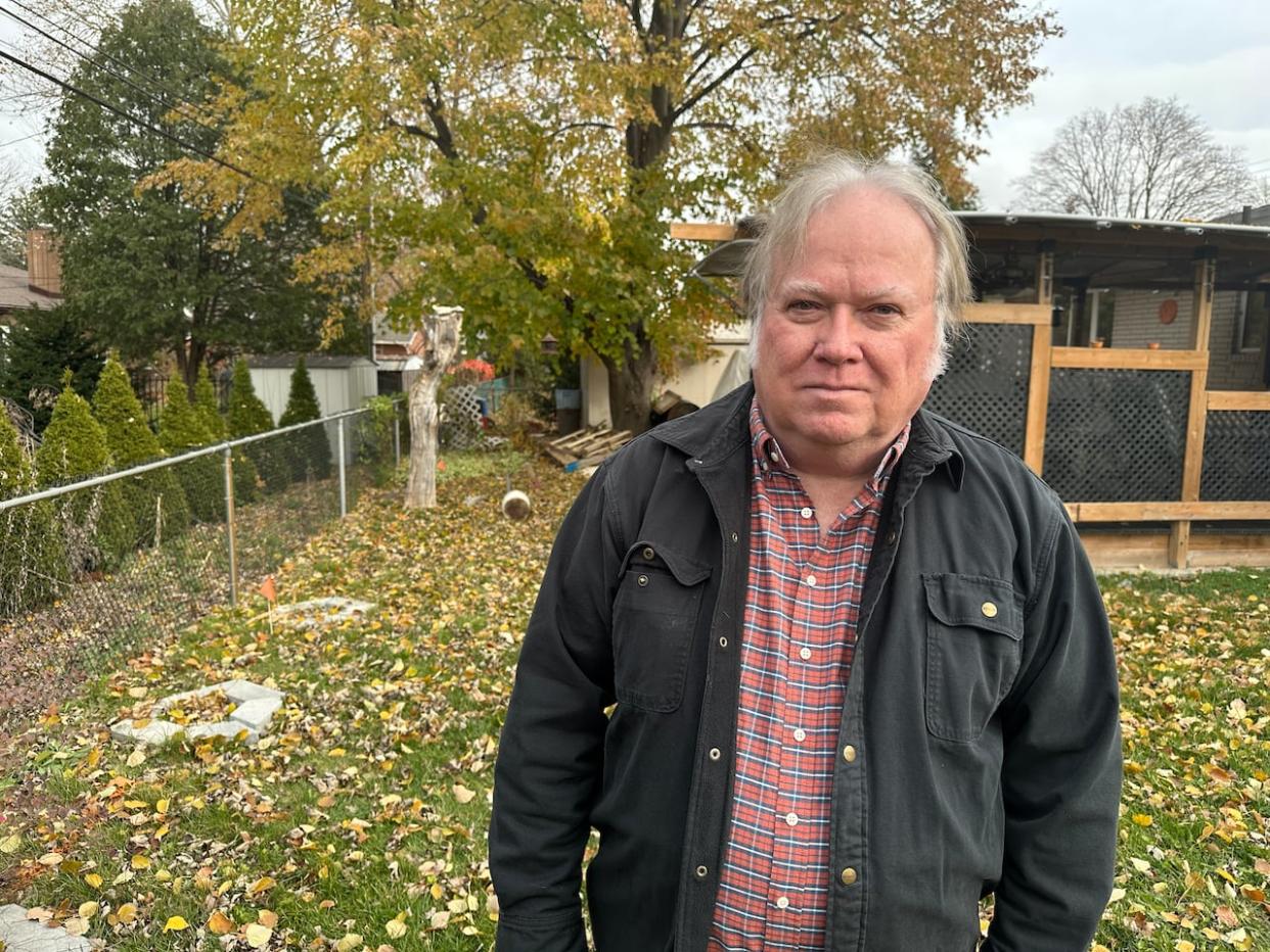 Tim Kennedy is a South Windsor resident who has been ordered to remove items from an unmaintained alley behind his house. (Dale Molnar/CBC - image credit)