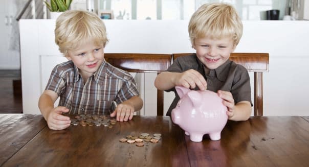 Twin boys and piggy bank