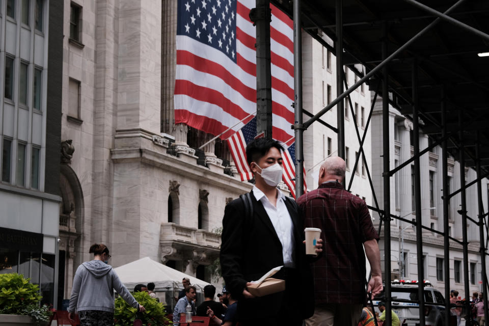 NEW YORK, NEW YORK - AUGUST 10: People walk by the New York Stock Exchange (NYSE) on August 10, 2021 in New York City. Markets were up in morning trading as investors look to a rare bipartisan effort in the Senate to pass a massive infrastructure bill that, if passed, will infuse billions into the American economy. (Photo by Spencer Platt/Getty Images)