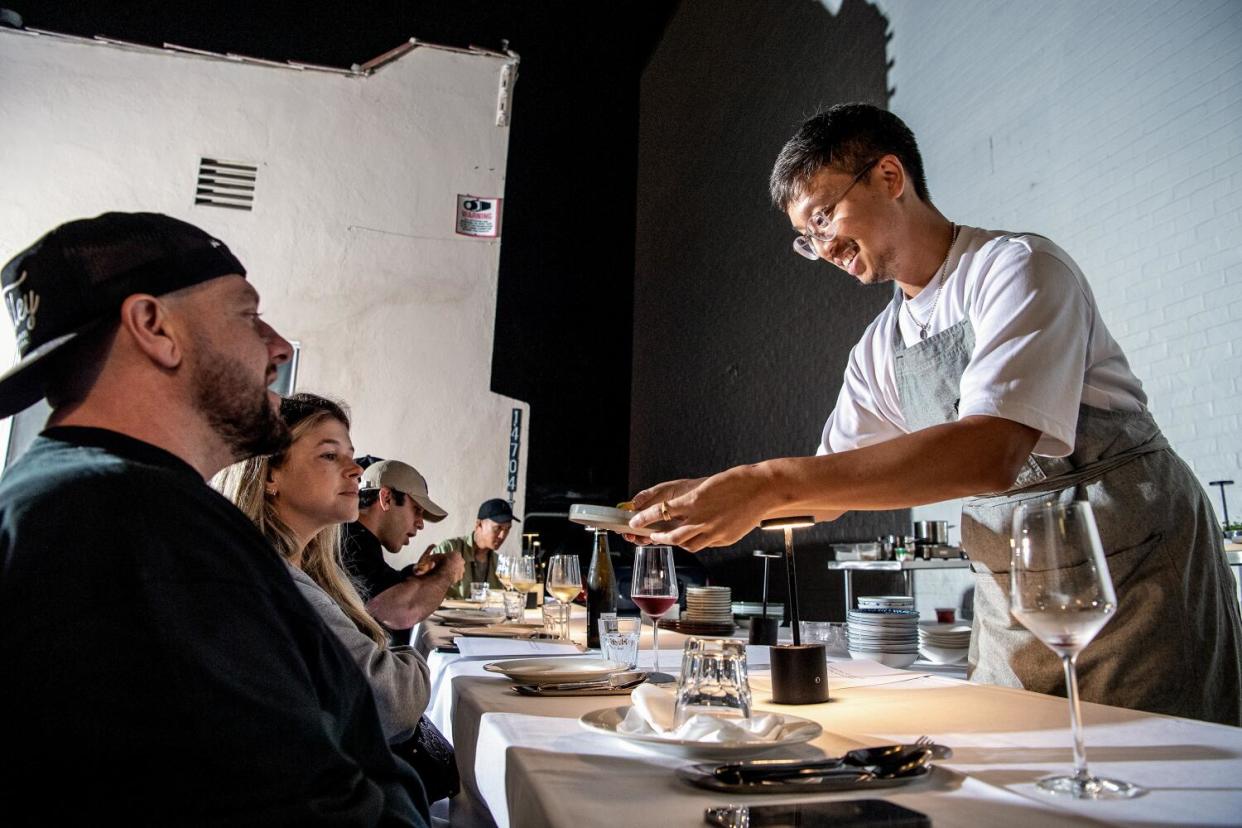 SHERMAN OAKS, CA - OCTOBER 14, 2022: Chef/Owner Justin Pichetrungsi serves the table at Anajak Thai