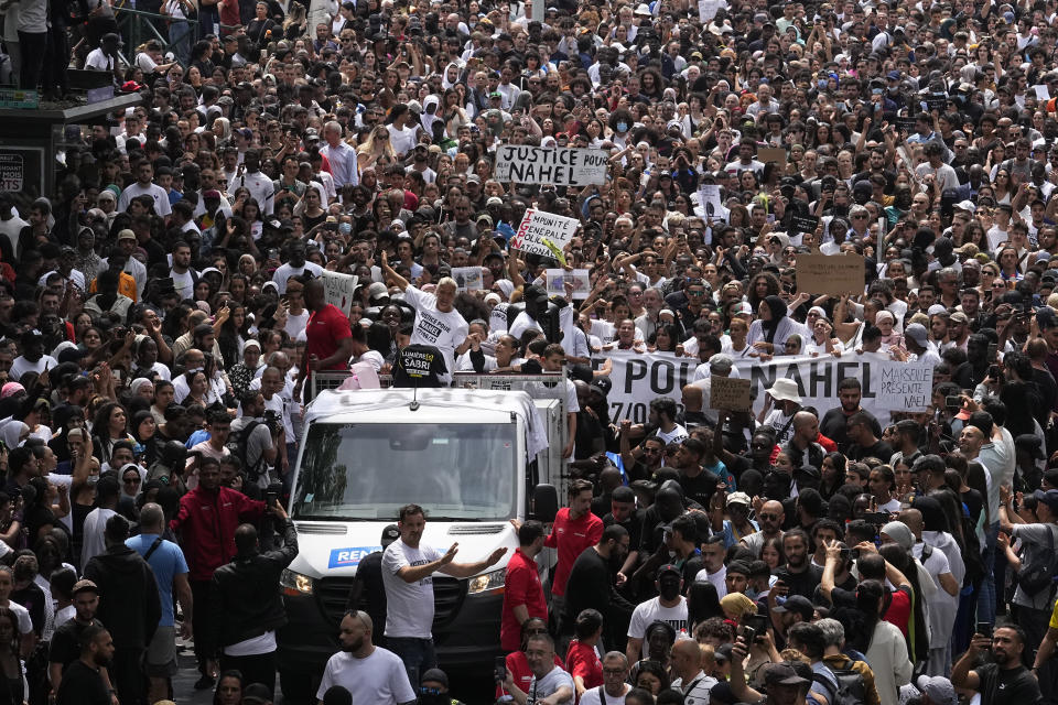 FILE - The mother of killed 17-year-old Nahel, center on truck, gestures during a march for Nahel, Thursday, June 29, 2023 in Nanterre, outside Paris. The killing of Nahel during a traffic check Tuesday, captured on video, shocked the country and stirred up long-simmering tensions between young people and police in housing projects and other disadvantaged neighborhoods around France. After more than 3,400 arrests and signs that the violence is now abating, France is once again facing a reckoning. (AP Photo/Michel Euler, File)