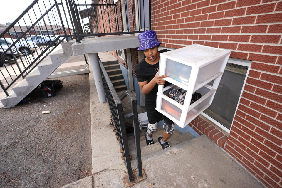 Monique Gant moves belongings out of an apartment after being evicted Wednesday, Jan. 31, 2024, in Westminster, Colo. Monthly rent has outpaced income across the U.S., and forced many to make tough decisions between everyday necessities and a home. In turn, a record number of people are becoming homeless and evictions filings have ratcheted up as pandemic-era eviction moratoriums and federal assistance ends. (AP Photo/David Zalubowski)