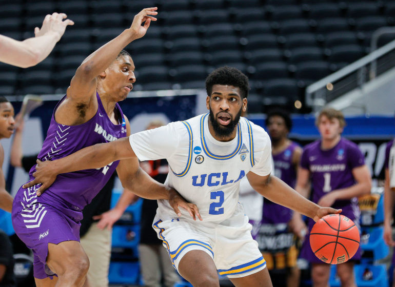 INDIANAPOLIS, INDIANA - MARCH 22: Cody Riley #2 of the UCLA Bruins handles the ball defended by Joe Pleasant.