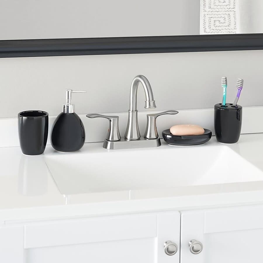 the black accessories on a bathroom sink